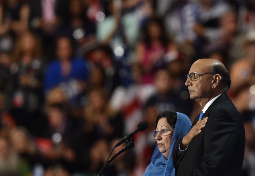 Khizr Khan, father of Humayun S. M. Khan, who was killed while serving in Iraq with the U.S. Army, stands on stage with his wife during the Democratic National Convention on July 28 in Philadelphia.