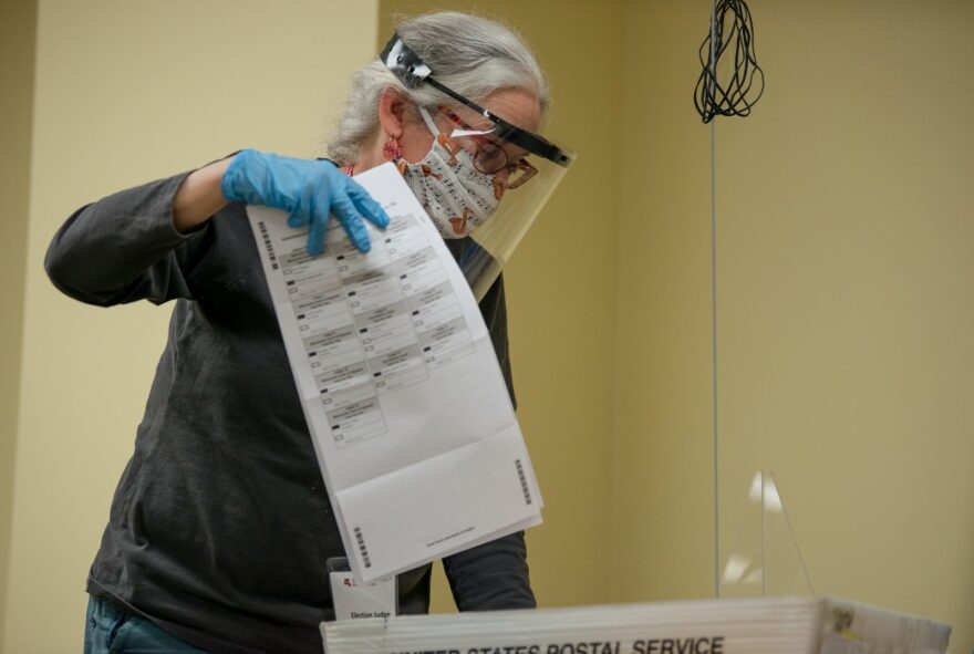 Volunteers process absentee ballots at Ramsey County's absentee ballot count center in St Paul, Minnesota. Last week the Eighth U.S. Circuit Court of Appeals ruled that all mail-in ballots received  in Minnesota after 8 p.m. on Election Day are to be set aside.