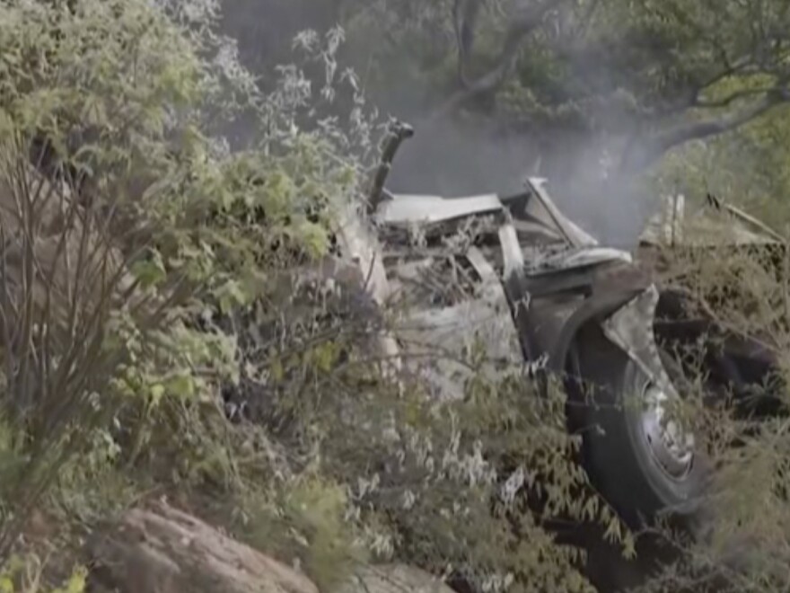 In this image taken from video provided by eNCA, a bus carrying worshippers headed to an Easter festival plunged off a bridge on a mountain pass and burst into flames in Limpopo, South Africa, on Thursday killing multiple people, authorities said.