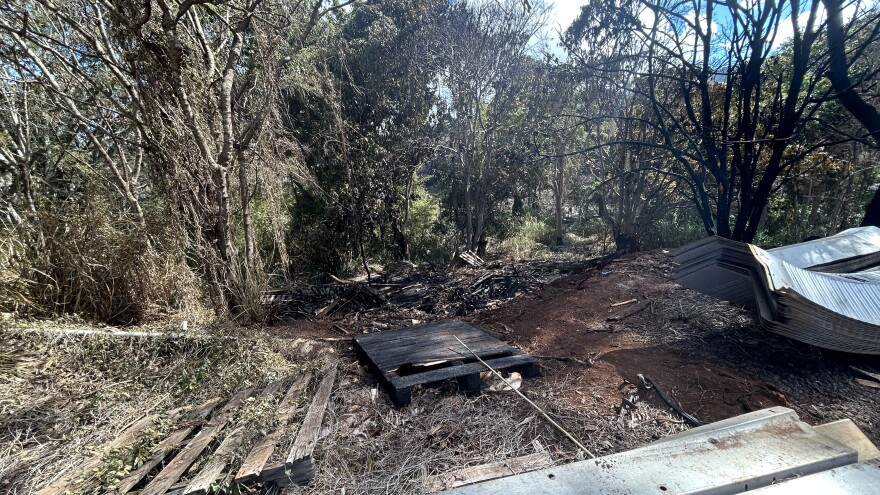 A charred wooden pallet was seen near an aquaponics farm at Kunia Camp after a fire. (Aug. 20, 2025)