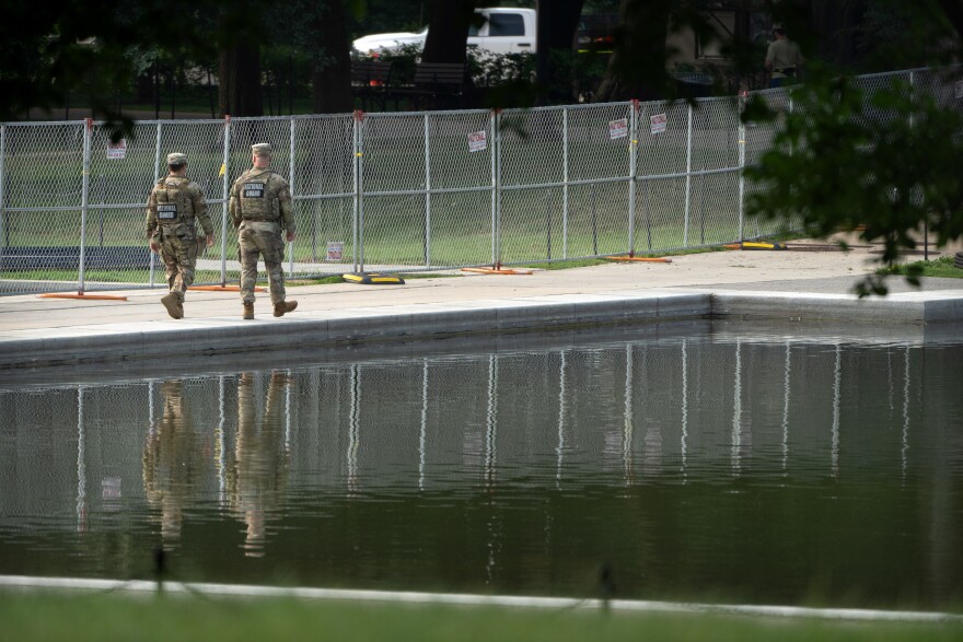 National Guard members walk near the Lincoln Memorial Reflecting Pool, Friday, July 10, 2026, in Washington.