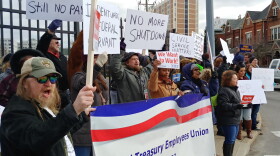 Demonstrators chanted slogans like "Open us up so we can get paid."