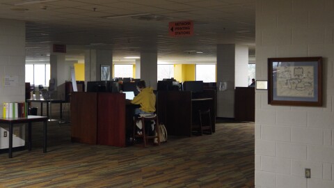 A WMU students works on their laptop at WMU's Waldo Library, one of several WMU facilities to lose power on Thursday