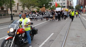 Murray Burnam leads marchers from the Hamilton County Courthouse into Over-the-Rhine.