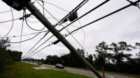 State troopers ride past downed power lines in the aftermath of Hurricane Isaias in Milton, Fla., Saturday, Oct. 10, 2026. (AP Photo/Gerald Herbert)