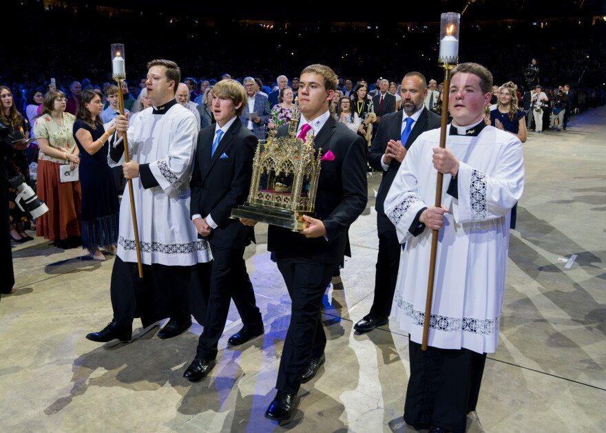 James Fulton Engstrom and his brother process while carrying a reliquary containing a portion of Archbishop Fulton J. Sheen's jawbone during Sheen's beatification Mass on Thursday at the Dome at America's Center in downtown St. Louis. Engstrom's recovery after being stillborn and without a pulse for 61 minutes was recognized by the Catholic Church as the miracle attributed to Sheen that cleared the way for the Emmy Award winner's beatification — just one step away from sainthood.