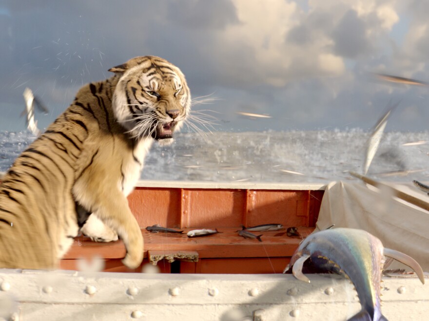 Richard Parker reacts to a school of flying fish.