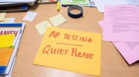 A sign that reads "AP Testing Quiet Please" is seen on a desk at Harding Preperatory Charter High School in Oklahoma City.