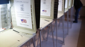 A voter fills out a ballot at a polling station in Terrace Park on Nov. 6, 2018.