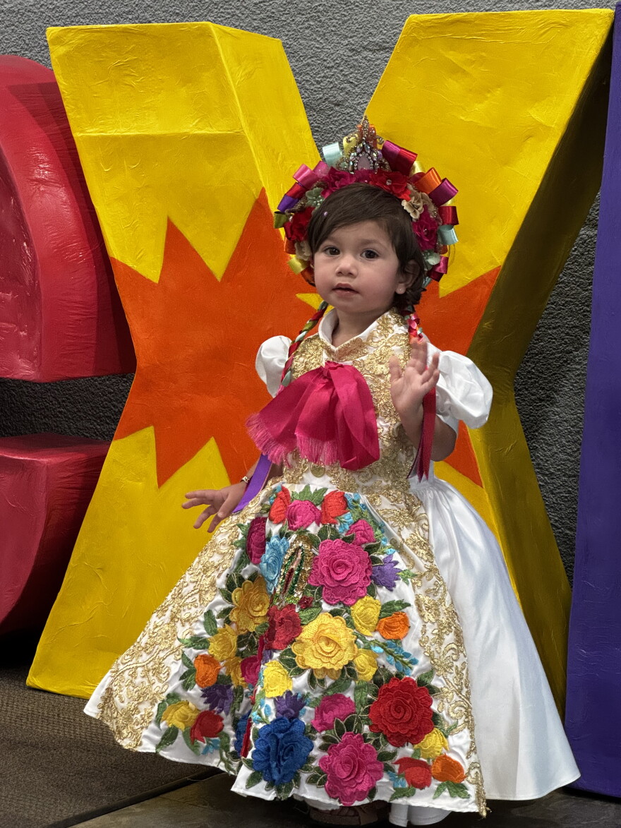 In the Mexican tradition, families dress up to attend the Grito de Independencia, and this adorable toddler proudly wears a traditional folkloric dress.