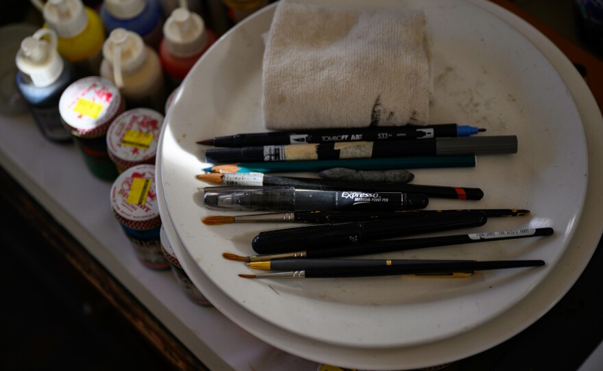Maurice Sendak’s paints, brushes, pens, and supplies sit on his studio desks. Sendak Foundation curator Jonathan Weinberg said that the paints Sendak often used were common poster paints, similar to the ones children use in school. “If you’ve ever used paint like that, you can’t understand how he was able to get the kind of effects that he was able to do,” Weinberg said.