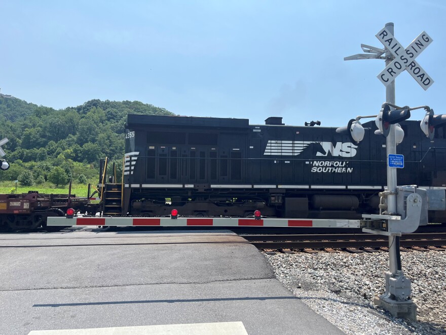 A train crossing a railroad crossing road. 