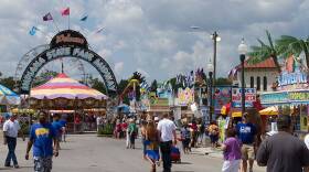Fair-goers walk near the midway during the 2015 Indiana State Fair.