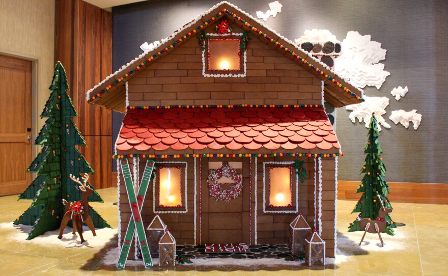 Fratellone said as a kid, she received a little snowman pin that was wearing an apron, holding spoons and a whisk, and on his apron, it said, "Baking Spirits Bright." That statement is now on the doormat of this gingerbread house.