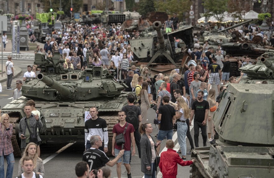 Ukrainians visit an avenue, where destroyed Russian military vehicles have been displayed in Kyiv, Ukraine.