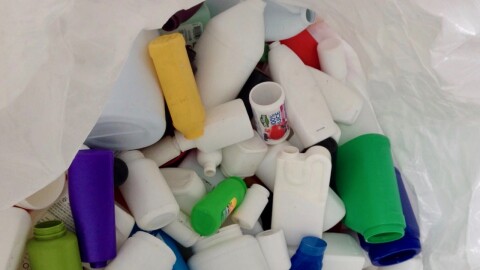 An assortment of plastic containers in a white bag