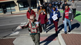 A group organized by Faith In Indiana marched to the site of Eric Logan's shooting and then the mayor's office building on Saturday.