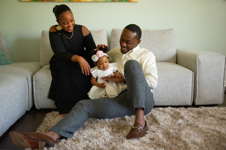 The Smith family playing in their Charlotte home. Brittany Smith and her husband both have good-paying jobs. She says she's lucky. She's the first in her family to go to college.