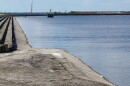  body of blue water to the right of a long bank of grayish sand, much of set up in stairlike levels 