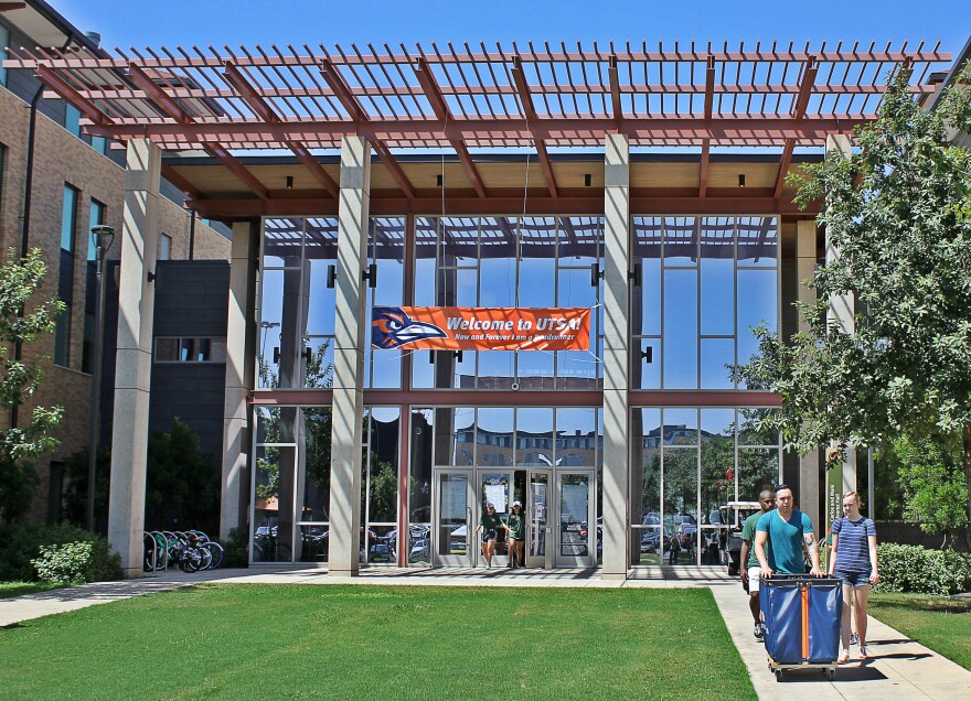 File Photo. Students walk out of UTSA's Alvarez Hall to pick up another load of  belongings during move-in day in Fall 2018.