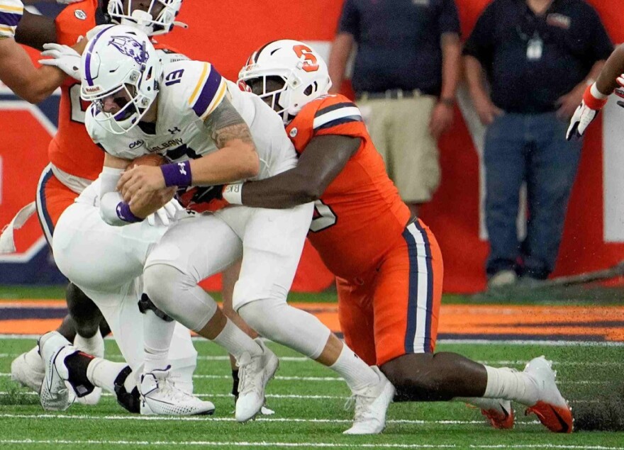 Syracuse defensive lineman Cody Roscoe wraps up Albany QB Jeff Undercuffler for a sack.