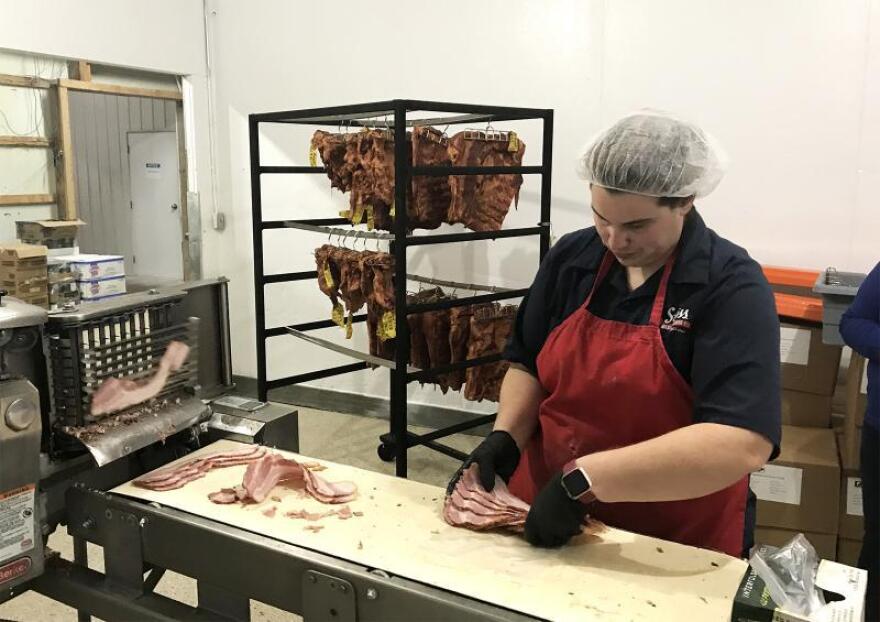A meatpacker at Swiss Meat and Sausage in Missouri in this 2019 file photo. This company could be eligible for CARES money from Missouri.