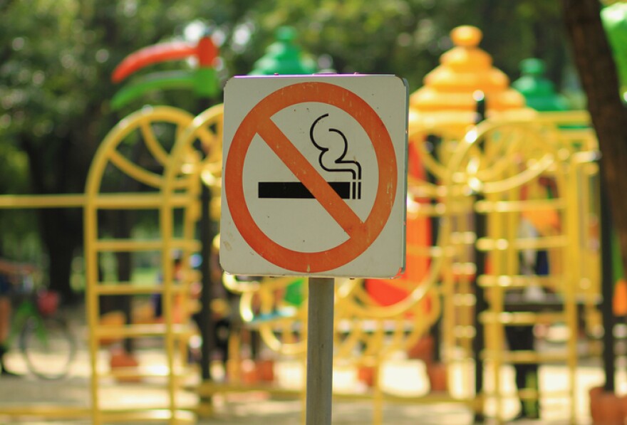 No smoking sign near children's playground in public park