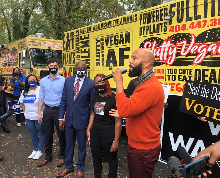 Democratic Senate Candidate Rev. Raphael Warnock, center, at GOTV rally in Jonesboro, Ga., with the rapper Common.