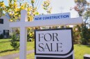 A sign is posted for a new home for sale