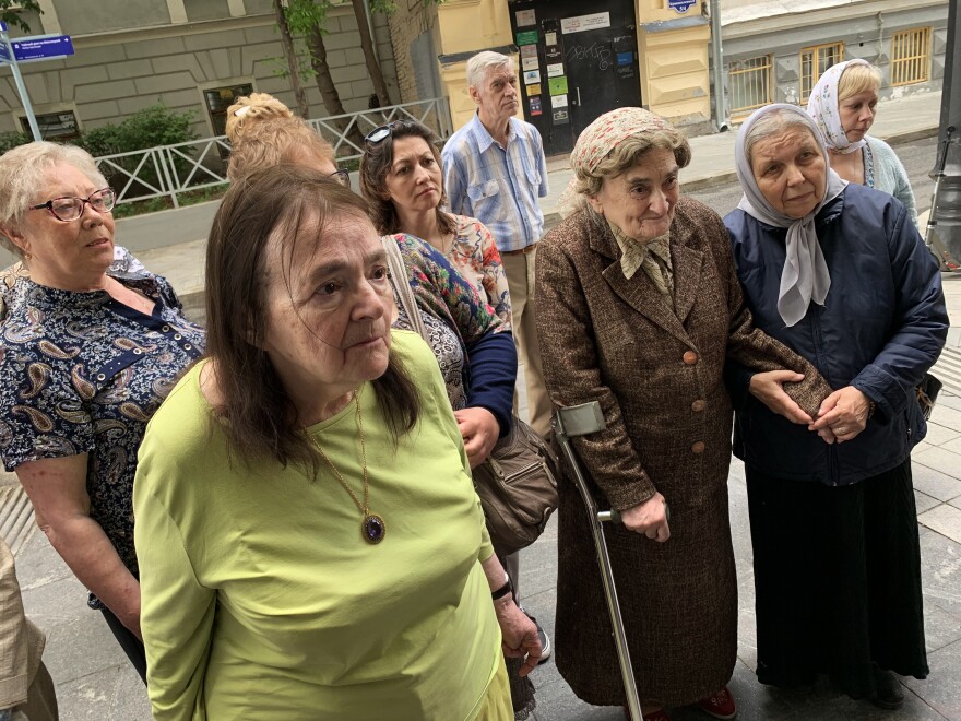 Ksenia Polunina (3rd right, wearing brown coat) visits her childhood apartment building in Moscow as a plaque memorializing her father is hung there. Her father Sergei Polunin was a scientist who was taken away from this building on a February night in 1938 — and then shot by Josef Stalin's secret police.