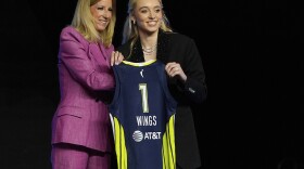 UConn's Paige Bueckers, right, poses for a photo with WNBA commissioner Cathy Engelbert after being selected first overall by the Dallas Wings during the first round of the WNBA basketball draft, Monday, April 14, 2025, in New York. (AP Photo/Pamela Smith)