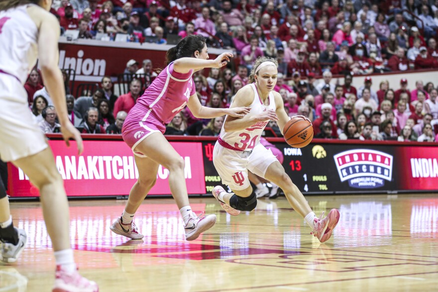 Indiana's Grace Berger drives against Iowa's McKenna Warnock during Thursday night's game at Simon Skjodt Assembly Hall.