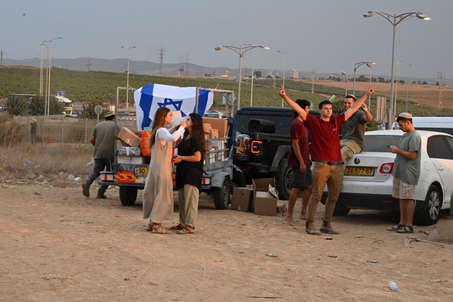 Young activists outside a gas station near Sderot, Israel, play music and pass out food to soldiers.