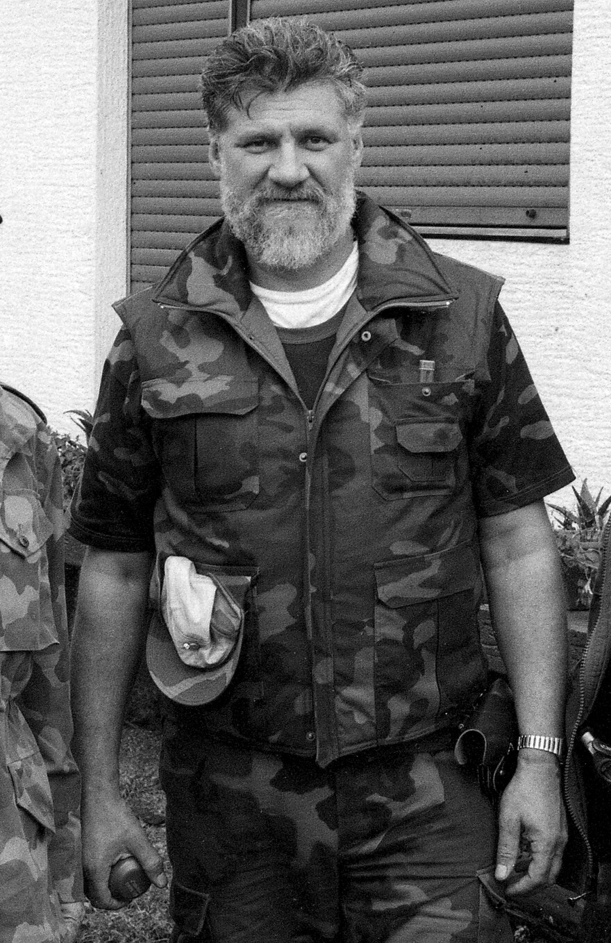 In a photo taken in 1991, Slobodan Praljak poses holding a hand grenade near the front line of the violence in Sunja, Croatia.