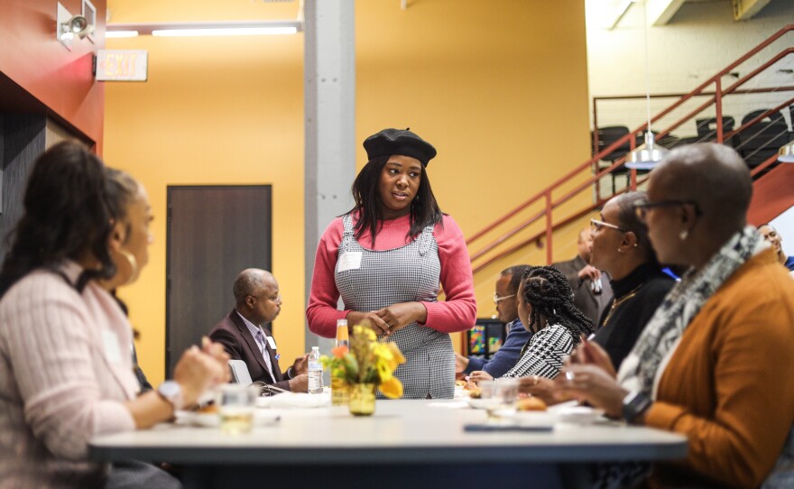 Gathering team member Taishma Council speaks to a group of attendees at GLMV Architecture.