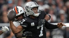 Cleveland Browns linebacker Devin Bush (30) sacks Las Vegas Raiders quarterback Geno Smith (7) during the first half of an NFL football game Sunday, Nov. 23, 2025, in Las Vegas. (AP Photo/Eric Gay)