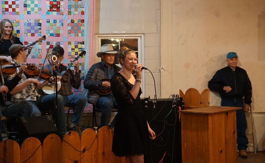 Brooke Holzemer, an online physical therapy student, calls out the moves at the Feb. 6 square dance night at Kearney Community Hall.