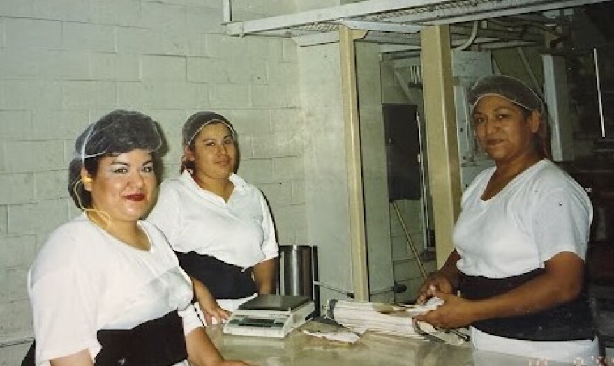 Three women at work inside the Judson Candy Company