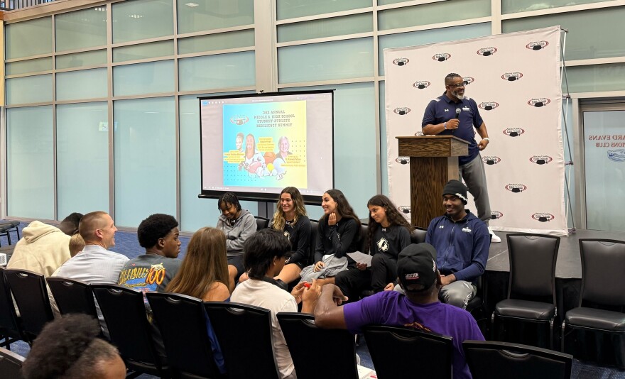 Santa Fe College coach David Lowery (top) gets the audience going before his players’ discussion panel.