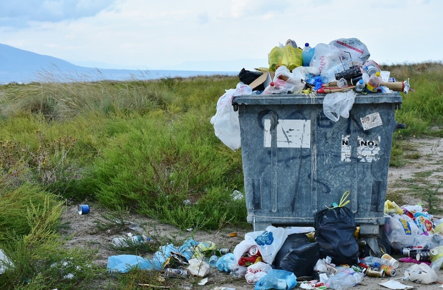 Garbage can overflowing with plastics