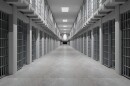 a hallway with rows of prison cells
