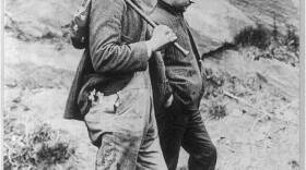 Two hobos walking the rails.