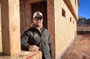 Jordan Wall stands next to a fourplex his company is building in Ivins, Utah, Dec. 3, 2025. Even as Utah strives to provide more attainable housing, Washington County is building fewer condos and townhomes.