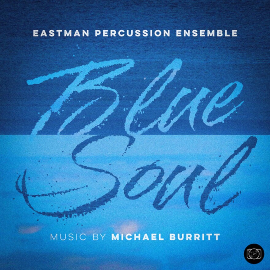 A square image divided in half, with dark blue background on top and a light blue background on bottom. "Blue Soul" is written in large script-like contrasting blue letters. At top, in white on the blue background it reads "Eastman Percussion Ensemble" and in the same lettering at the bottom, "Music by Michael Burritt" 