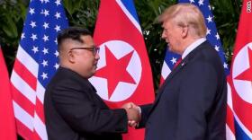 Kim Jong Un and President Trump shake hands at Singapore summit