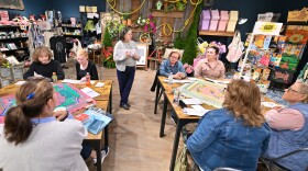 Lexie Kelly teaches a group of new mah-jongg players about