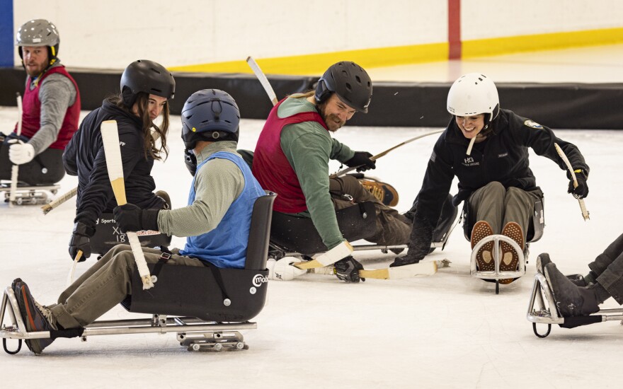 A group of firefighters plays sled hockey during Higher Ground's recent recreation therapy program in Sun Valley