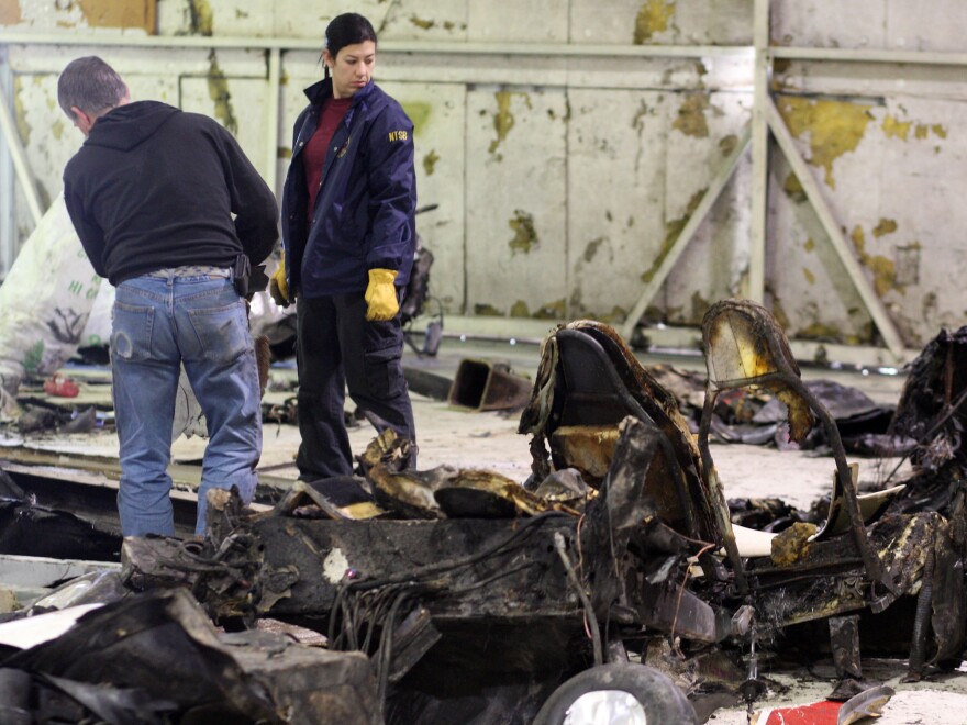 Inspectors conducts an examination of the wreckage of a Lancair experimental aircraft that crashed on Feb. 4, 2012. The plane was piloted by by Micron CEO Steve Appletonwho was killed in the crash.