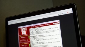 In this May 13, 2017 file photo, a screenshot of the warning screen from a purported ransomware attack, as captured by a computer user in Taiwan, is seen on laptop in Beijing. (Mark Schiefelbein/AP)