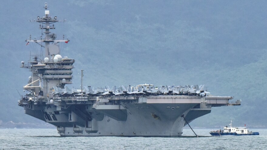 The acting secretary of the Navy is seeking a more thorough review of "decisions of the chain of command surrounding the COVID-19 outbreak aboard the USS Theodore Roosevelt." The aircraft carrier is seen here as it enters the port in Da Nang, Vietnam, last month.